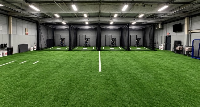 Indoor batting cage bays with pitching machines at 1% Sports Akron